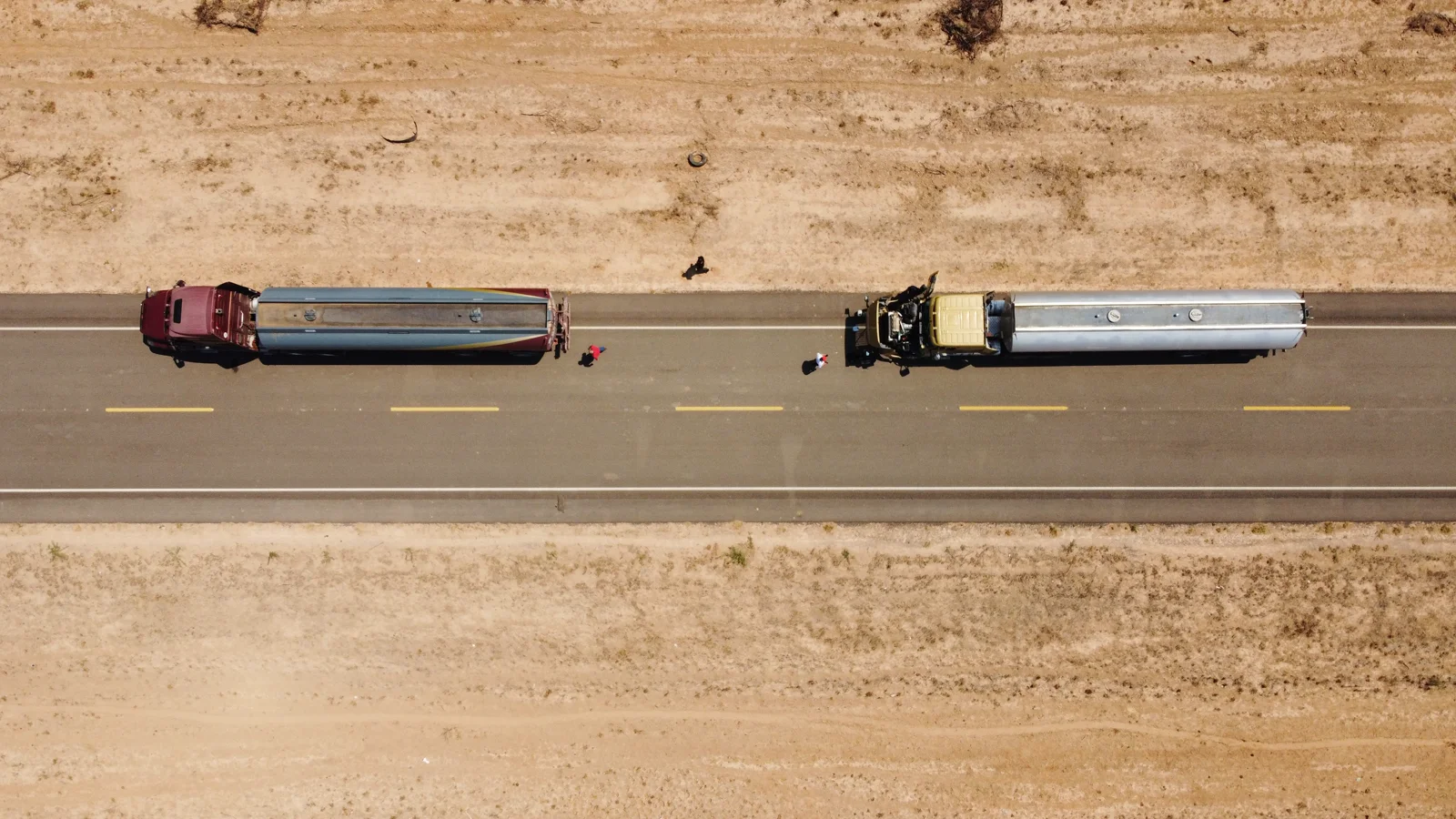An aerial view of tanker trucks along a freight corridor